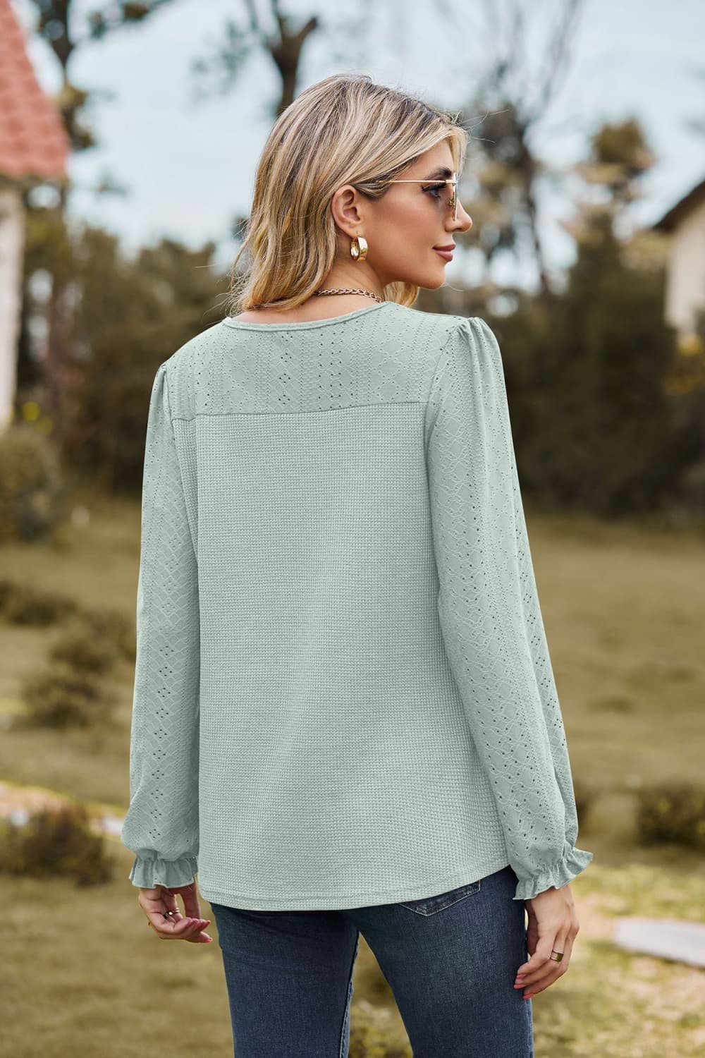 Eyelet knit puff sleeve blouse with round neckline