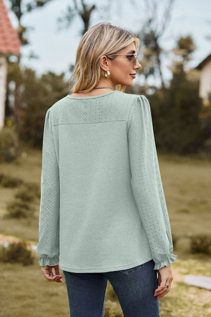 Eyelet knit puff sleeve blouse with round neckline