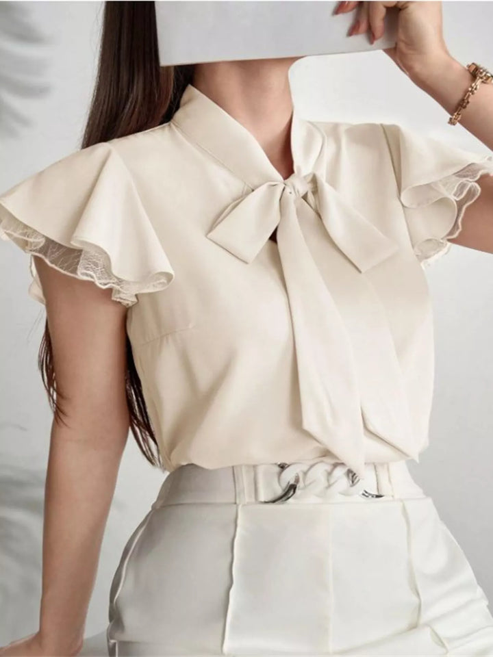 Tie-neck ruffle cap sleeve blouse with lace trim