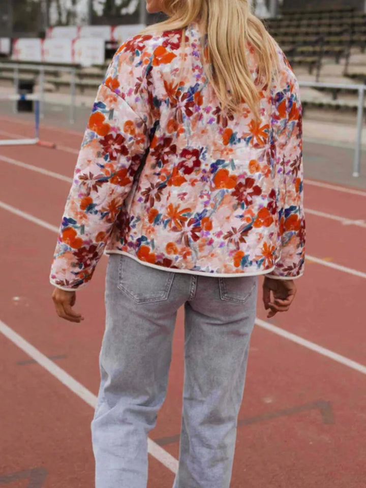 Floral print quilted jacket with contrast piping and patch pockets
