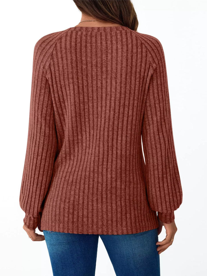 Ribbed knit long sleeve top with decorative shoulder buttons