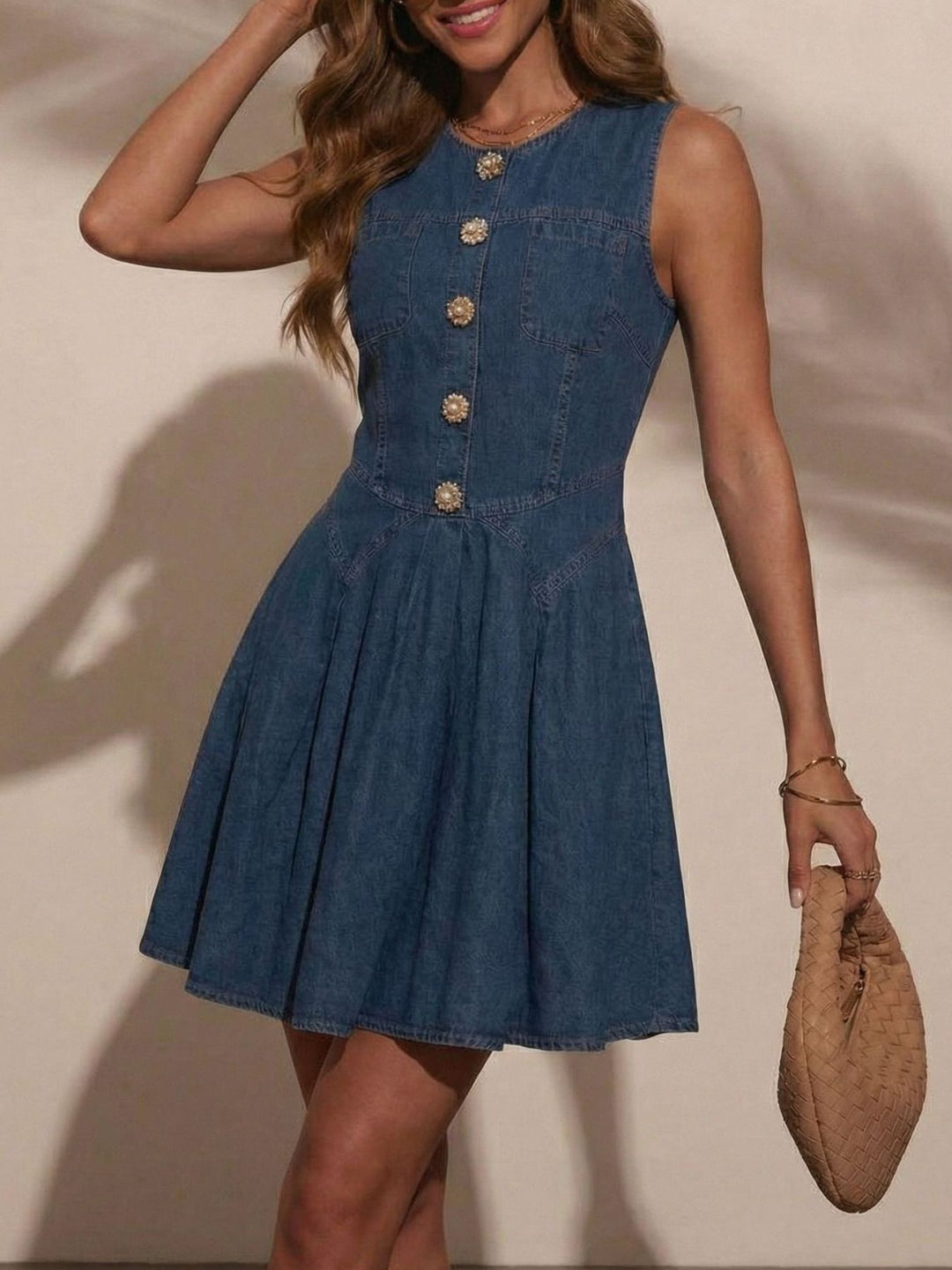 Sleeveless denim mini dress with jeweled buttons