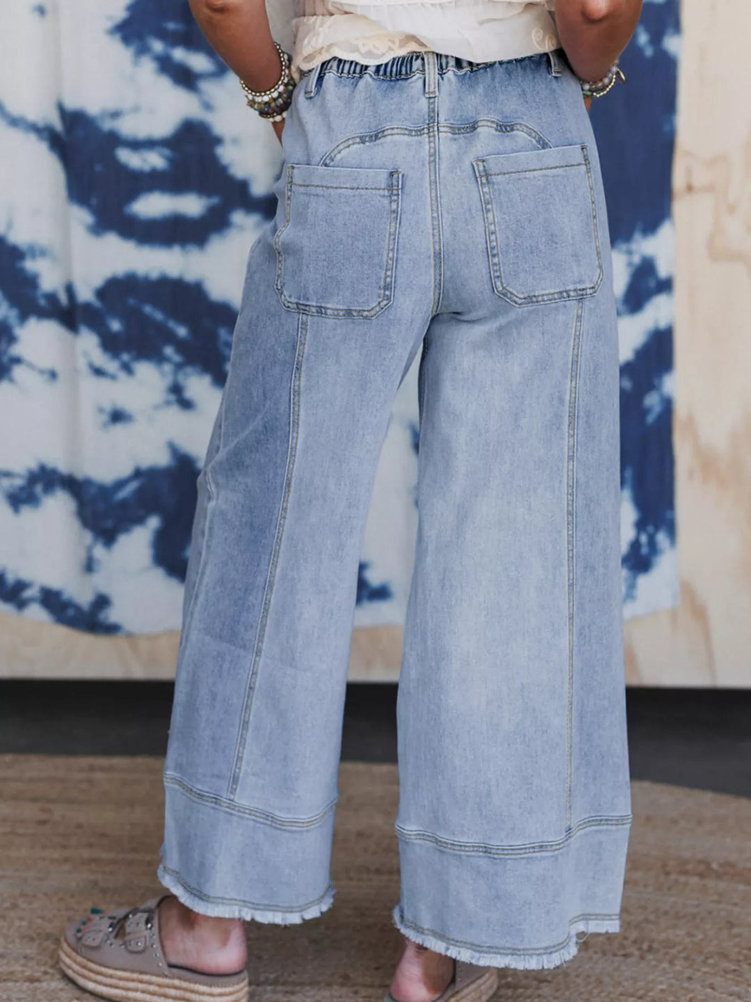 Wide-leg drawstring jeans with raw frayed hem
