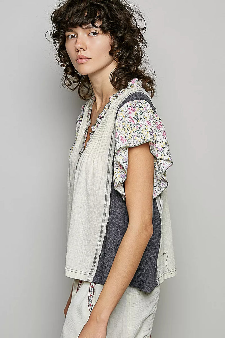 V-neck woven blouse with floral ruffle trim and pintuck front
