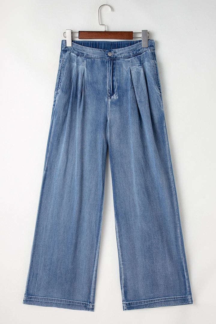 Pleated high-rise wide-leg jeans with deep pockets