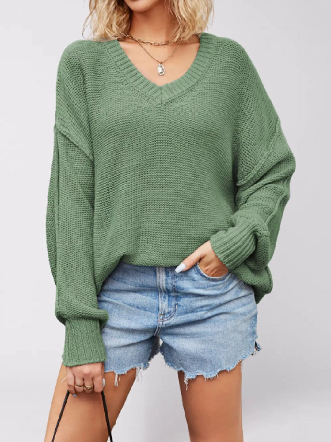 Drop shoulder V-neck sweater with exposed seams