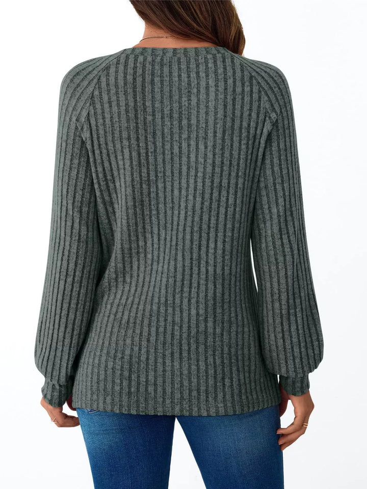 Ribbed knit long sleeve top with decorative shoulder buttons