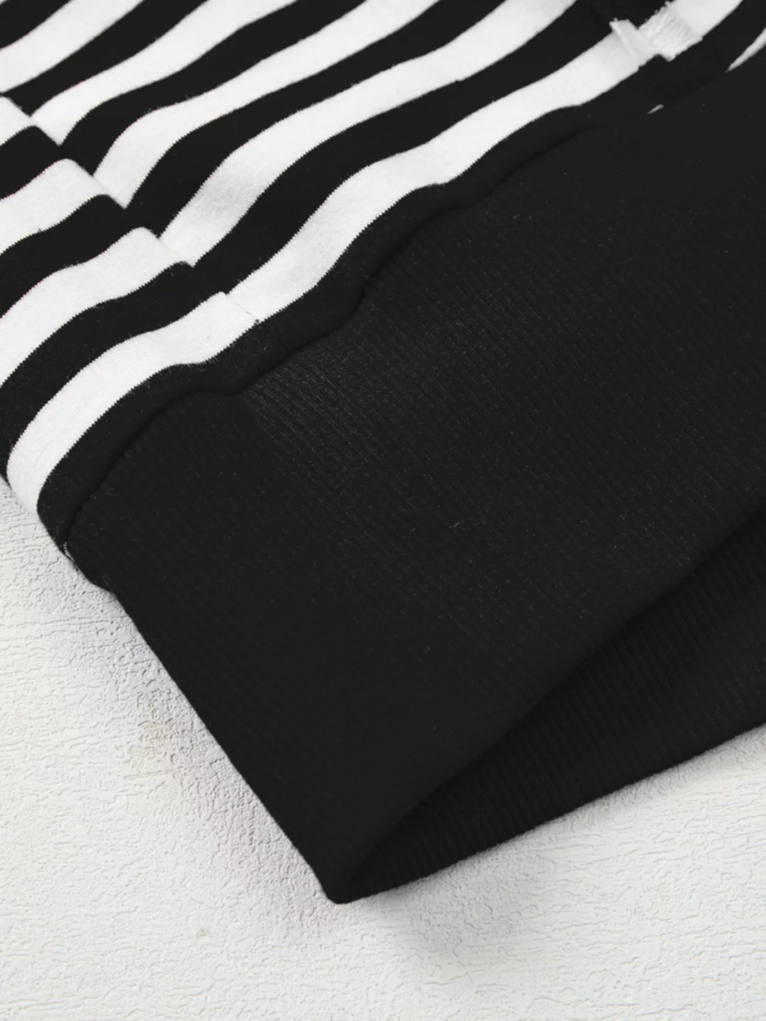 Exposed seam striped drop-shoulder pullover top