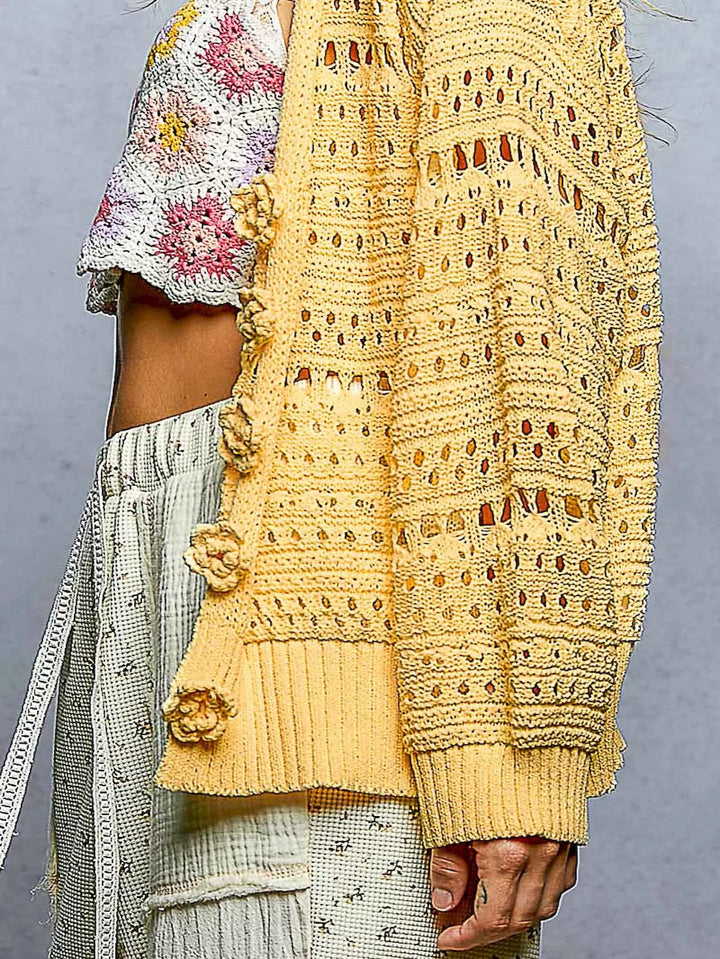 Open-knit V-neck cardigan with 3D floral button closure