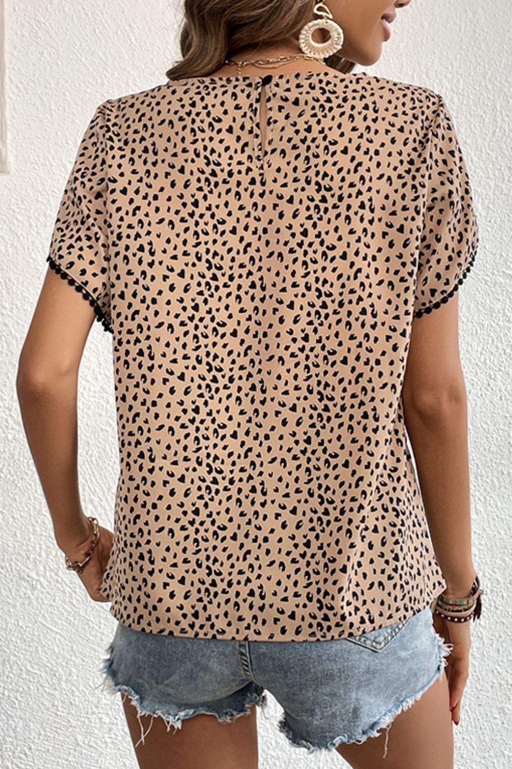 Leopard print petal sleeve blouse with pom pom trim