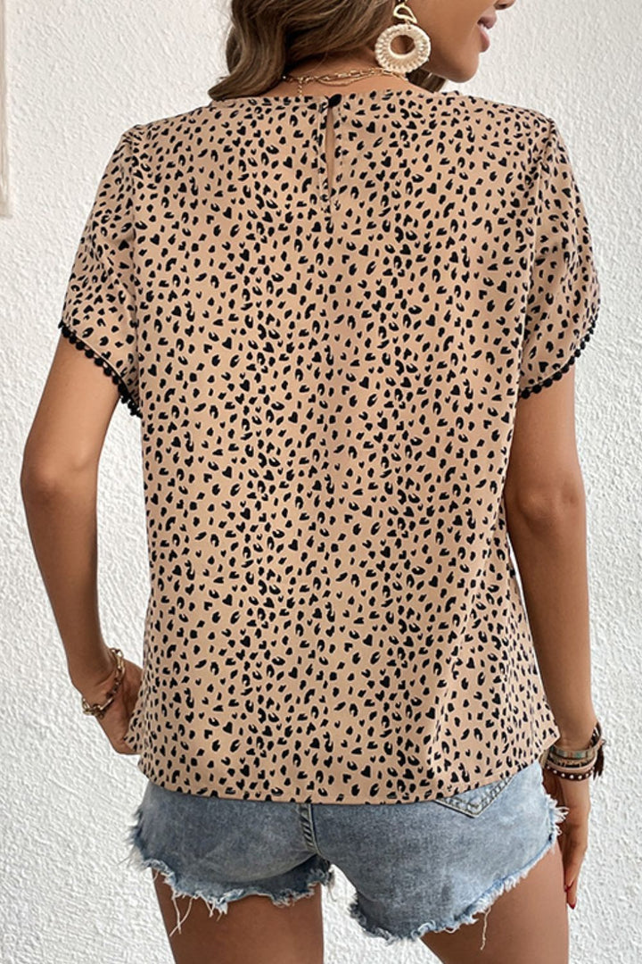 Leopard print petal sleeve blouse with pom pom trim
