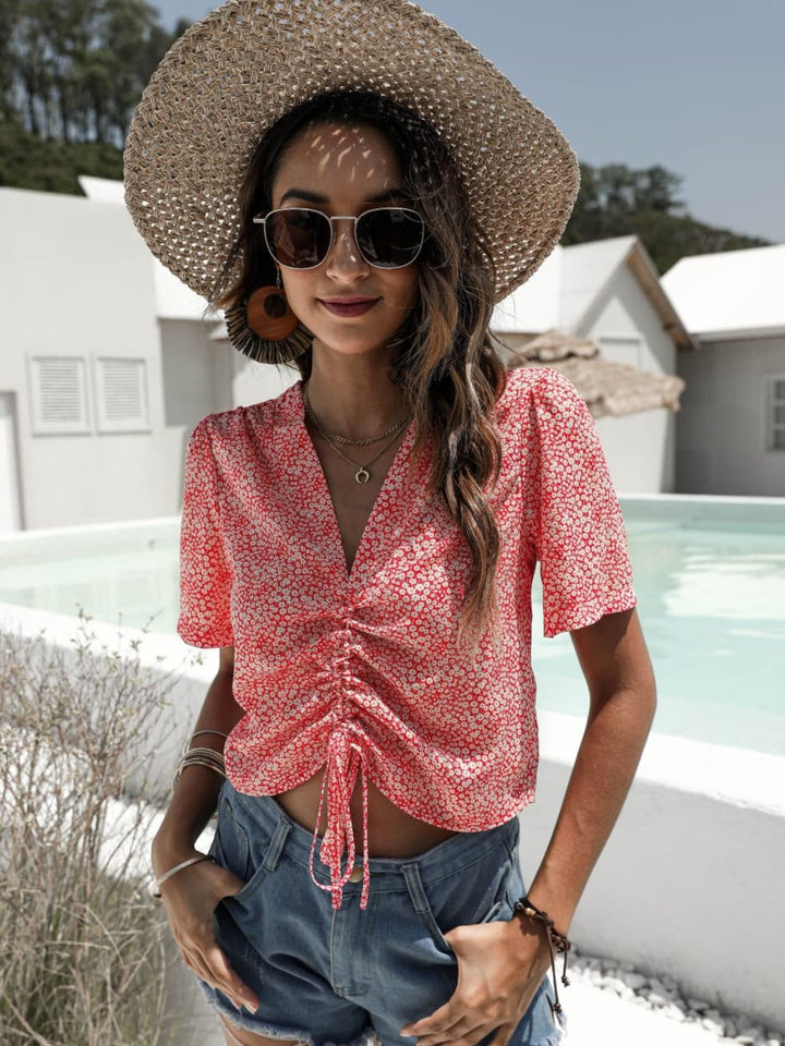 Floral drawstring crop top with deep V-neck and flutter sleeves