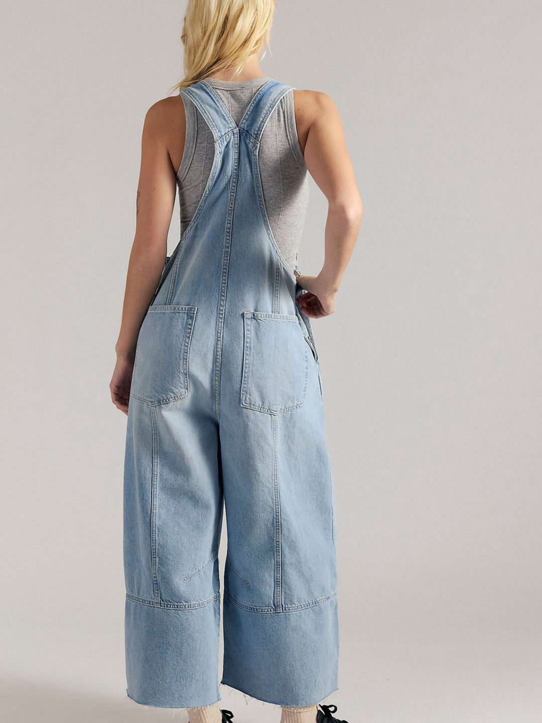 Pleated wide-leg denim overalls with raw hem