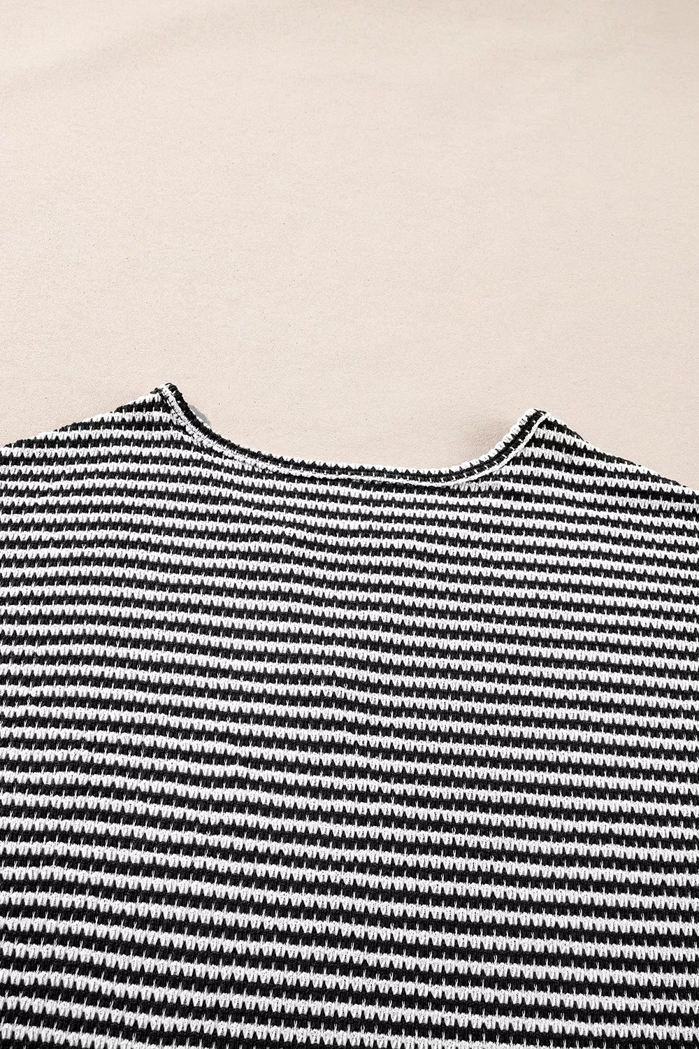 Striped textured knit top with notched V-neck and cuffed sleeves