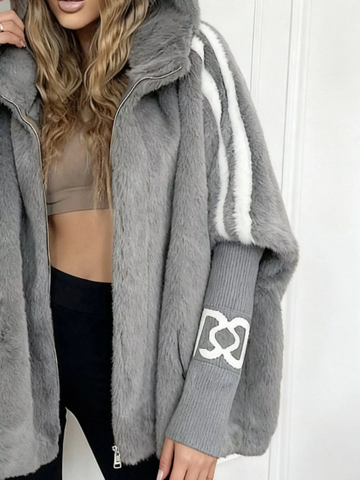Hooded faux fur coat with striped trim and knit sleeves