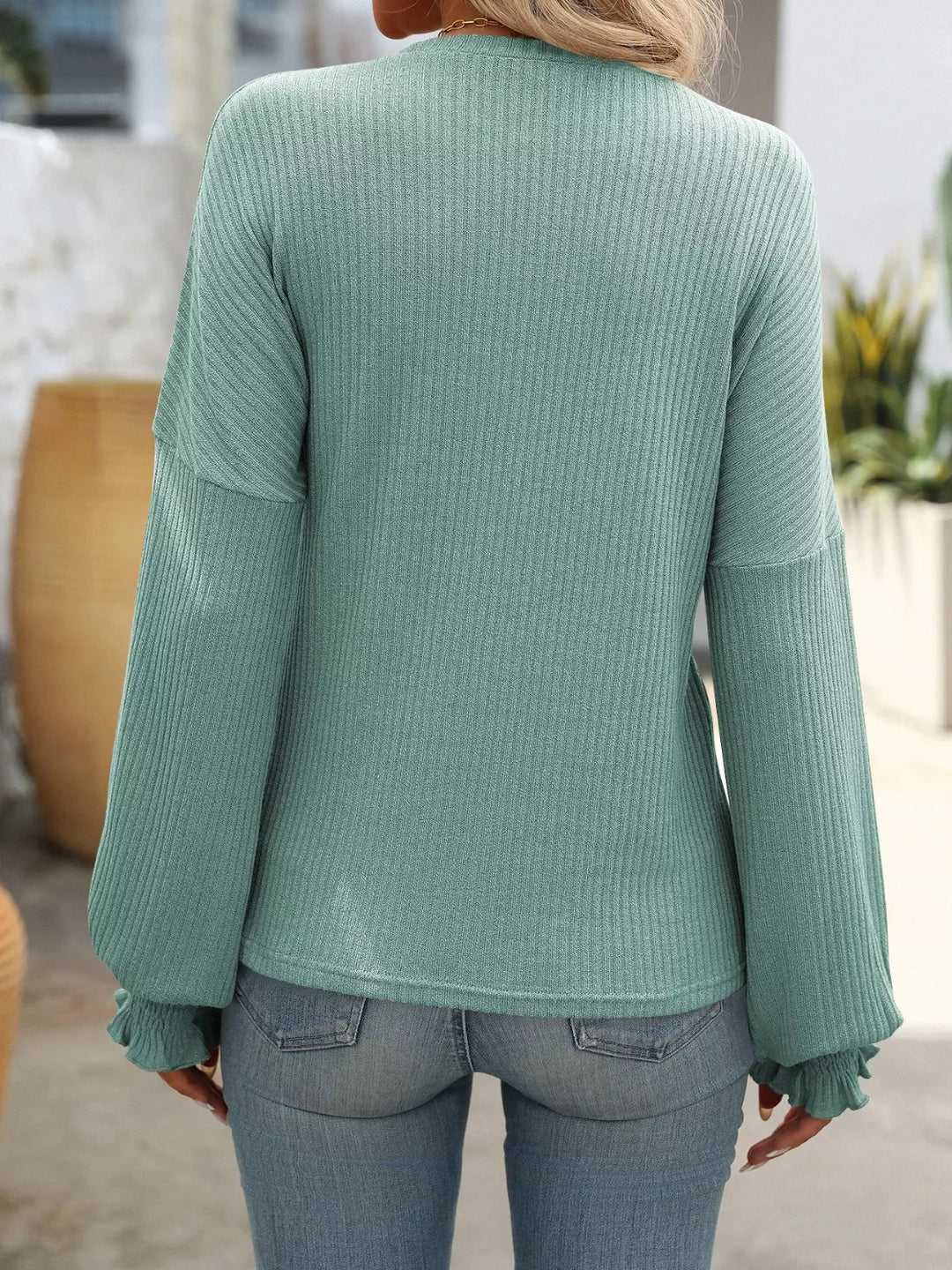 Ribbed knit crew neck top with ruffled smocked cuffs