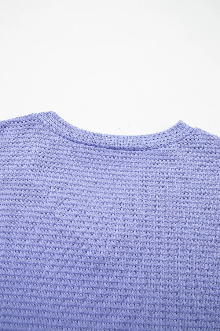 Plus size waffle knit V-neck top with cuffed short sleeves
