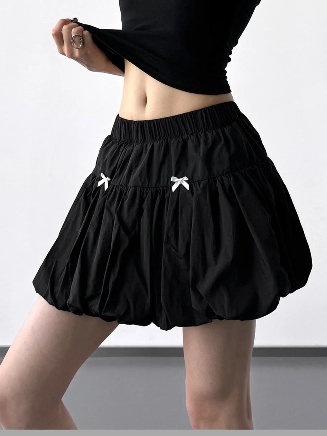 Bubble hem mini skirt with bow trim and elastic waist