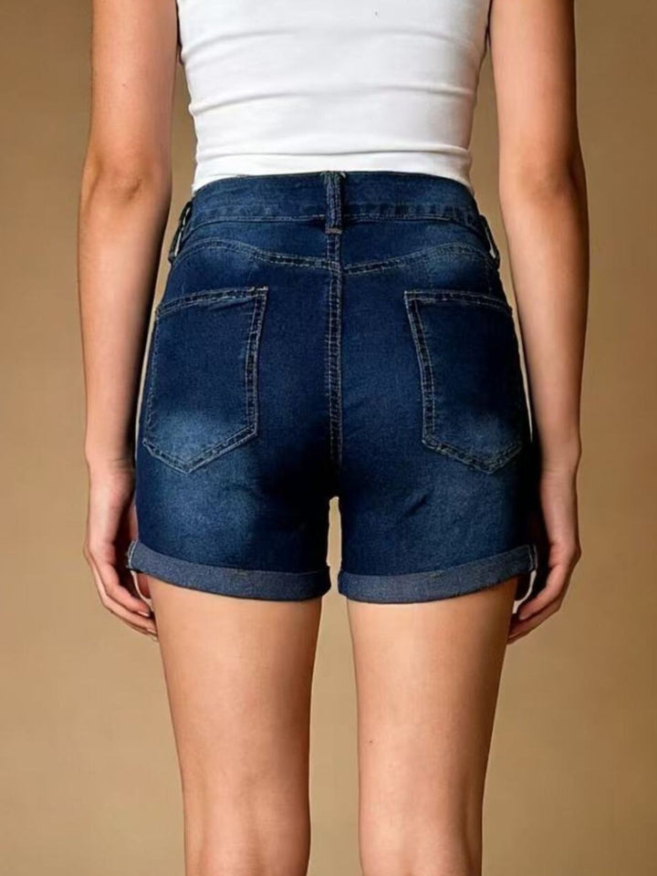 Distressed mid-rise denim shorts with cuffed hem