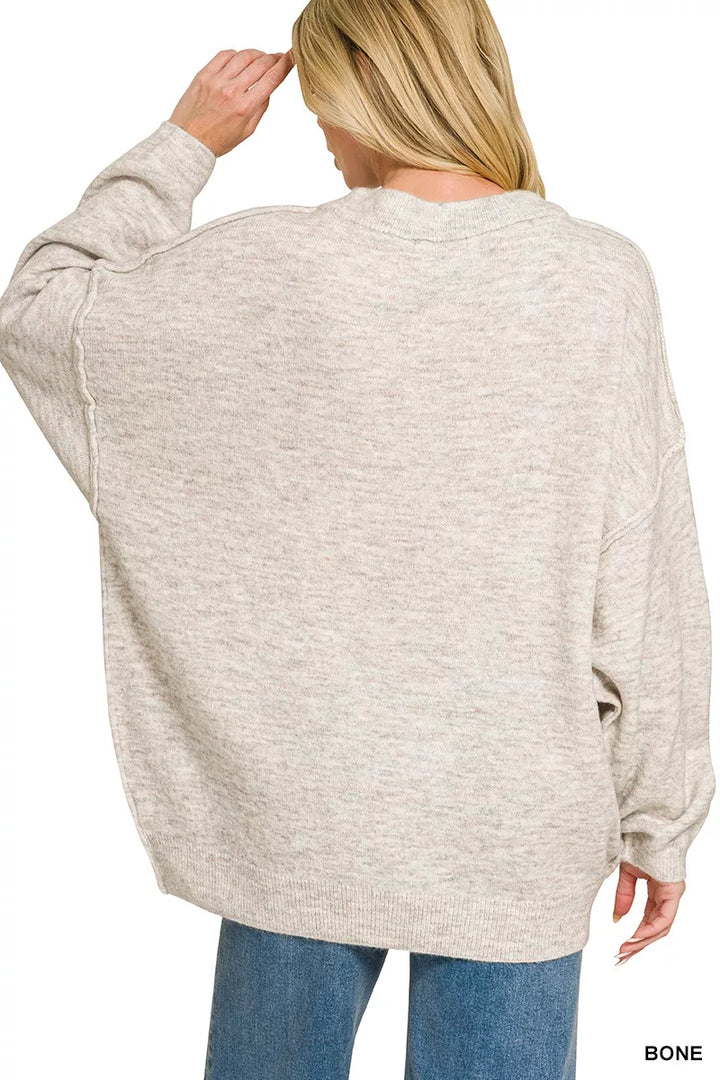 Oversized exposed-seam melange crew neck sweater