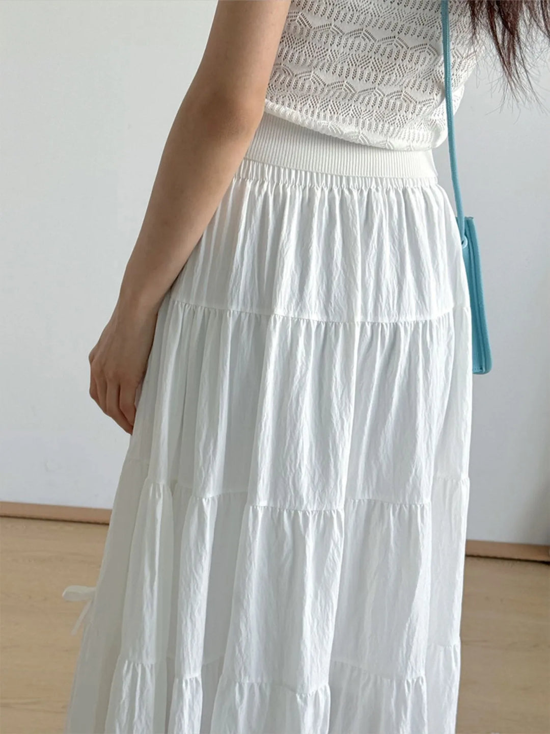 Tiered bow-accent maxi skirt with elastic smocked waist