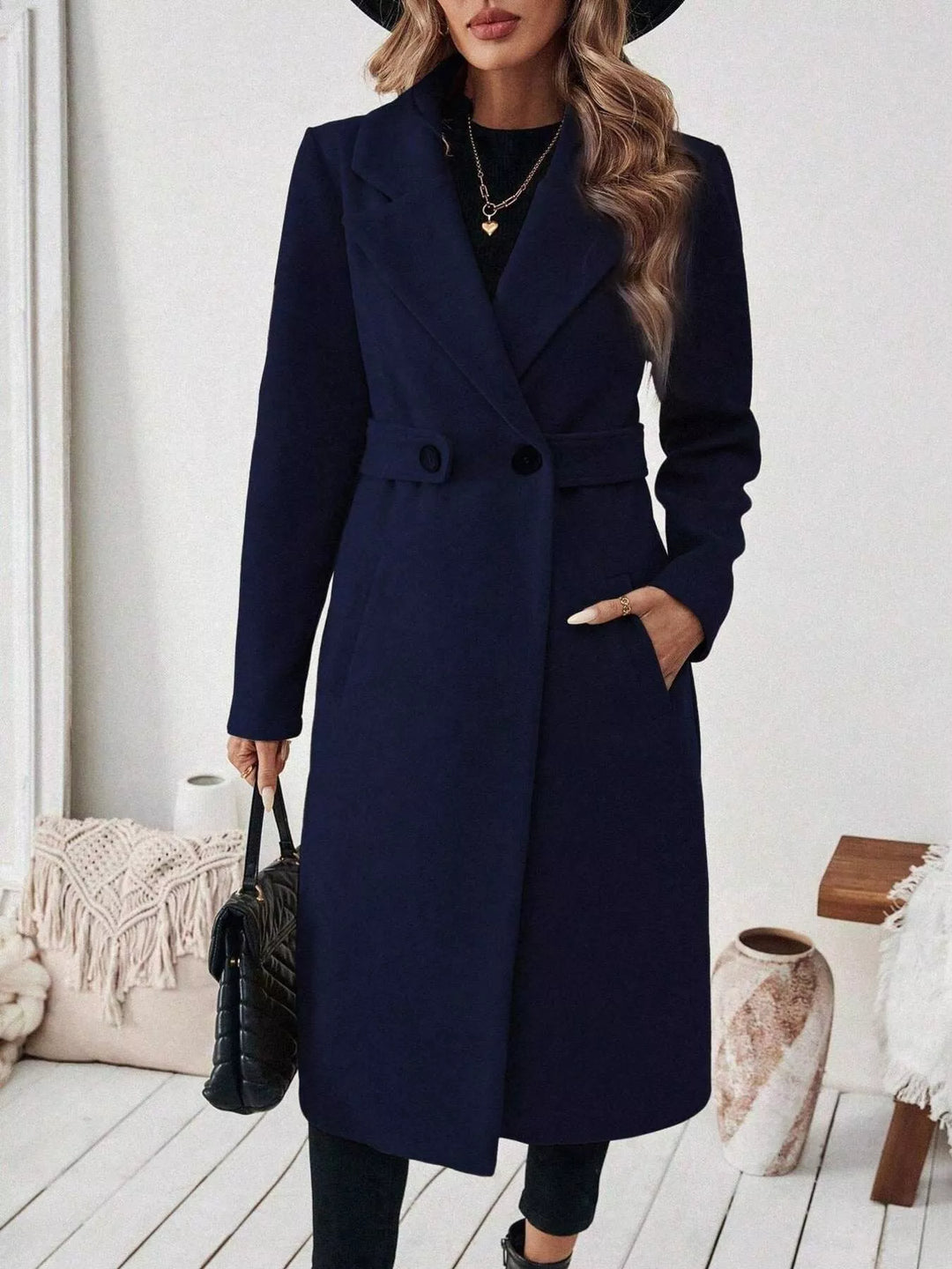 Longline notch lapel coat with single-button waist tab