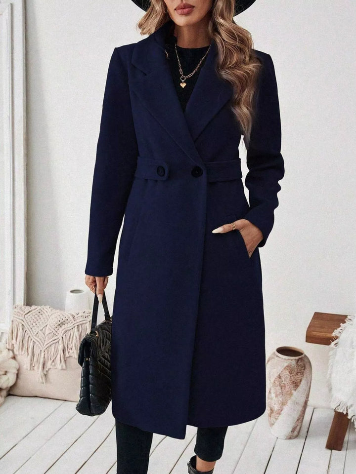 Longline notch lapel coat with single-button waist tab