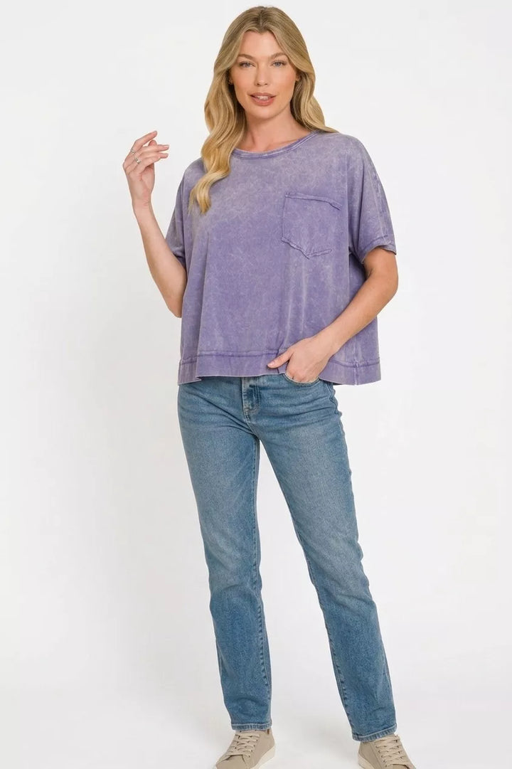 Acid-washed oversized cotton tee with chest pocket and raw hem