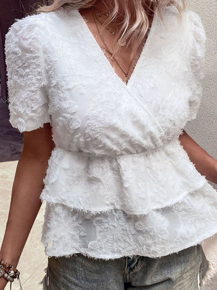 Textured surplice neck peplum top with puff sleeves