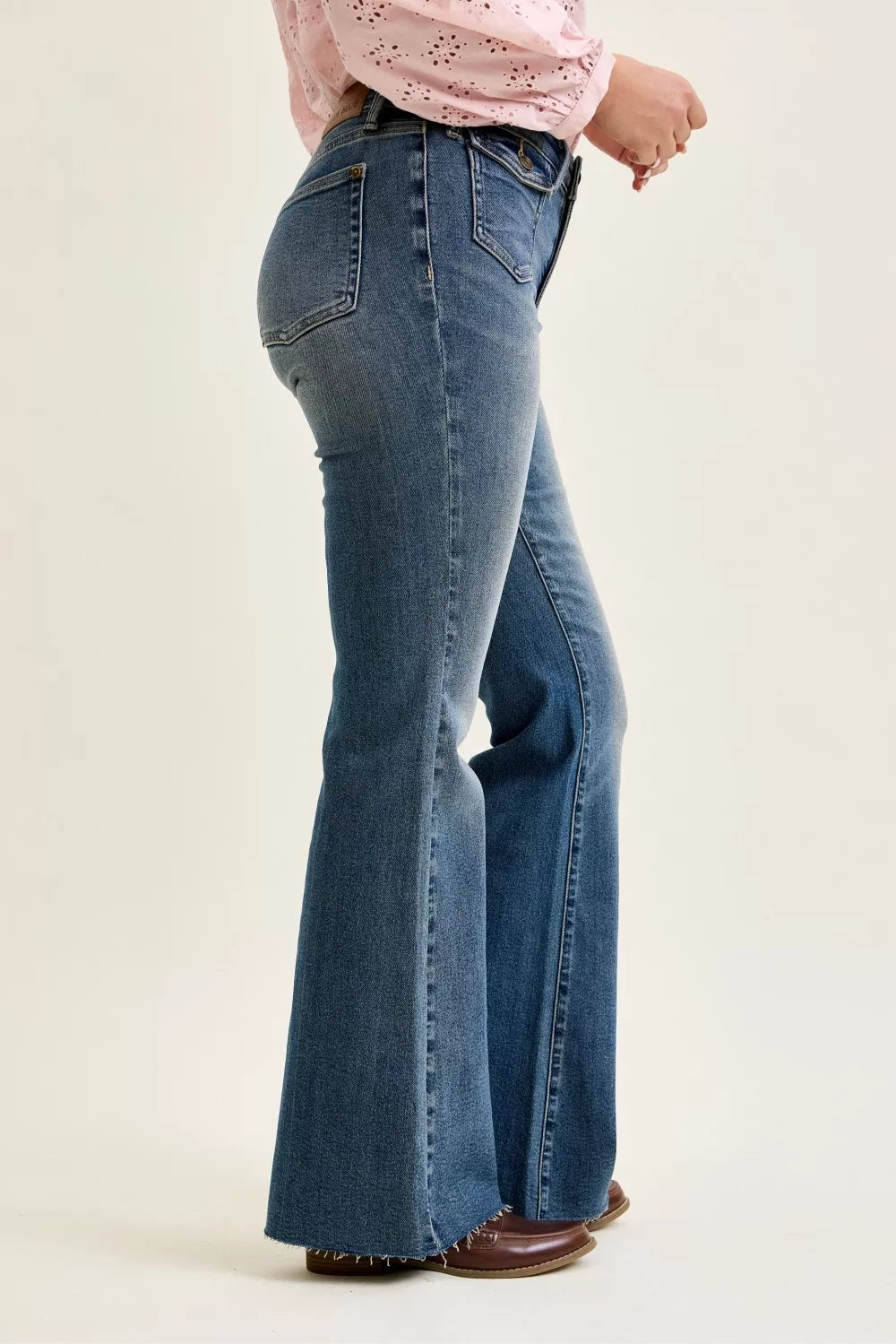 Judy Blue mid-rise flare jeans with front flap pockets and raw hem