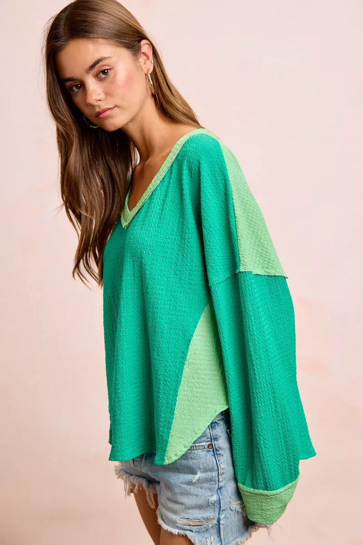 Color block long sleeve textured jersey top with raw-cut edges