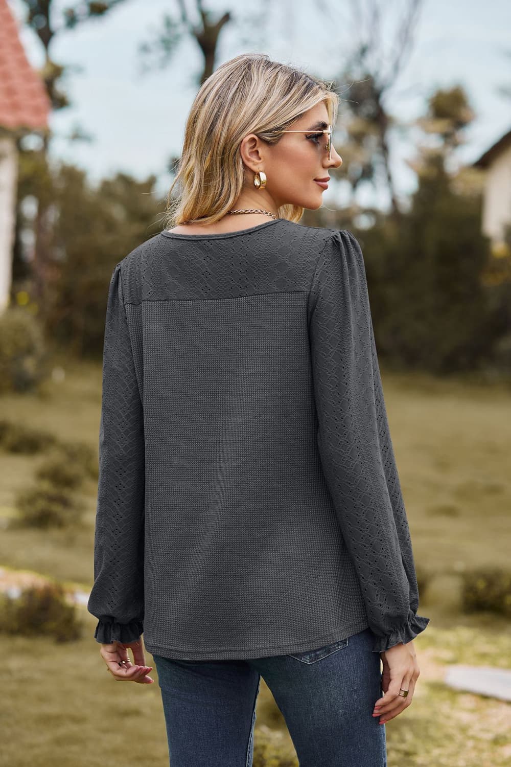 Eyelet knit puff sleeve blouse with round neckline