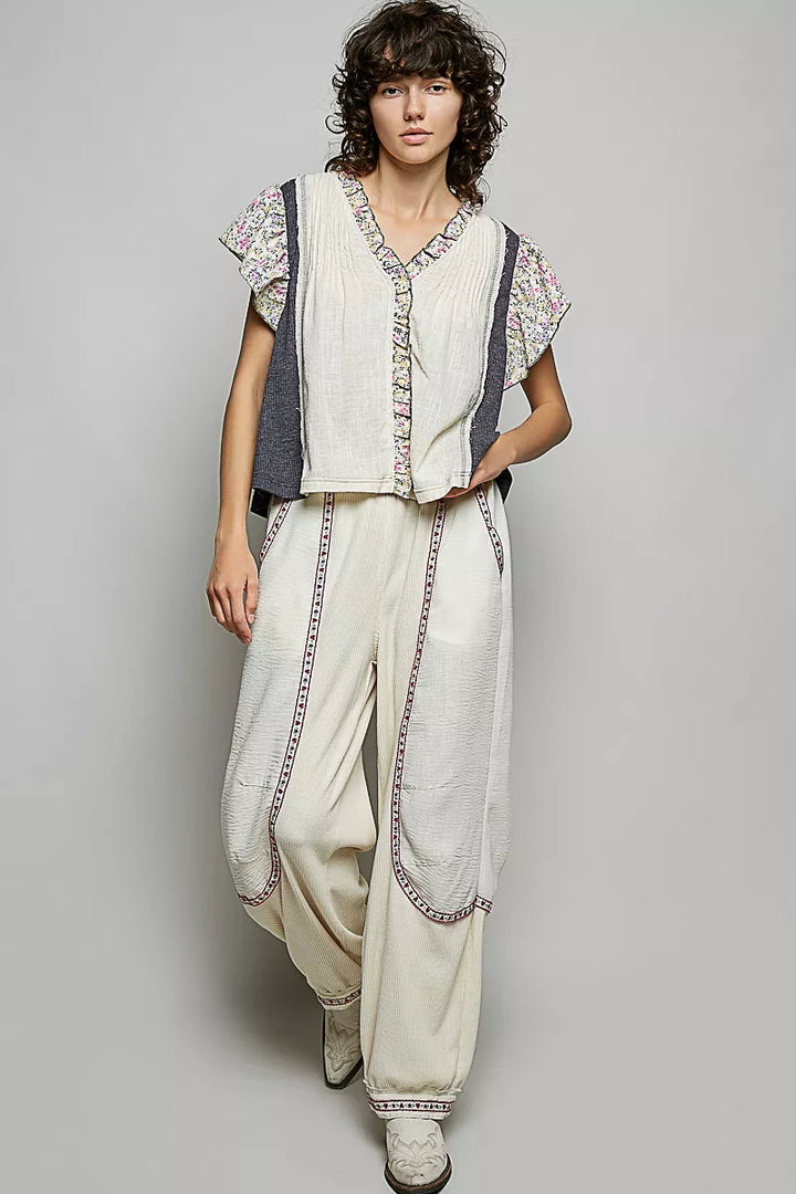 V-neck woven blouse with floral ruffle trim and pintuck front