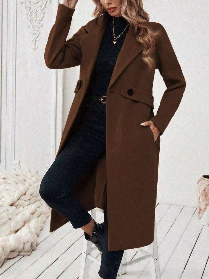 Longline notch lapel coat with single-button waist tab