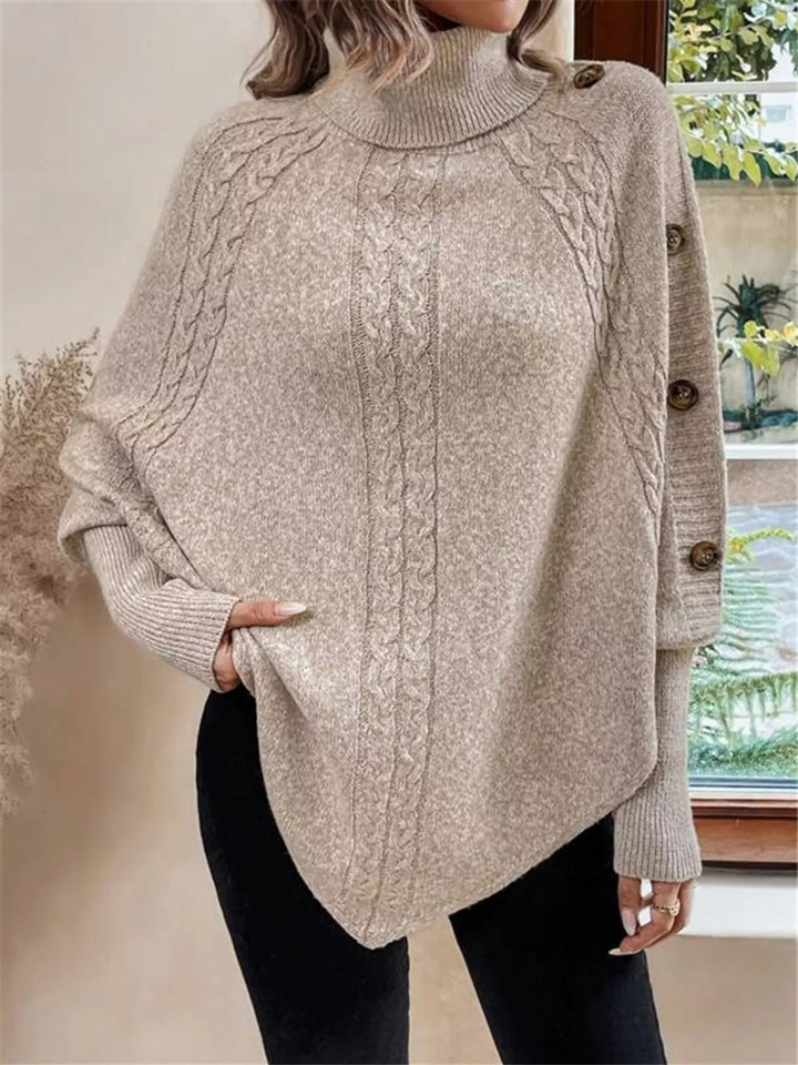 Cable knit turtleneck cape sweater with button shoulder