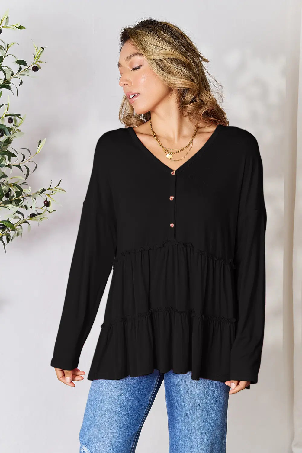 Half-button long sleeve blouse with tiered ruffle hem