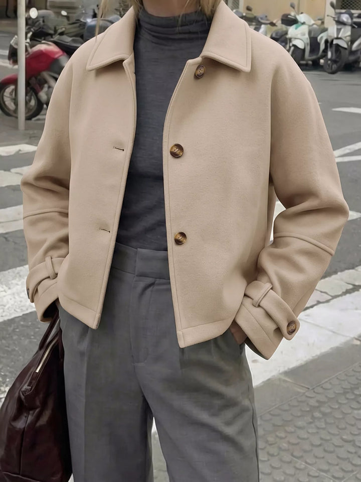 Cropped collared button-up jacket with cuff tabs