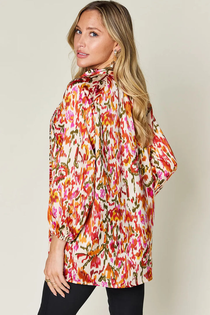 Abstract print button-up shirt with tie neck and long sleeves