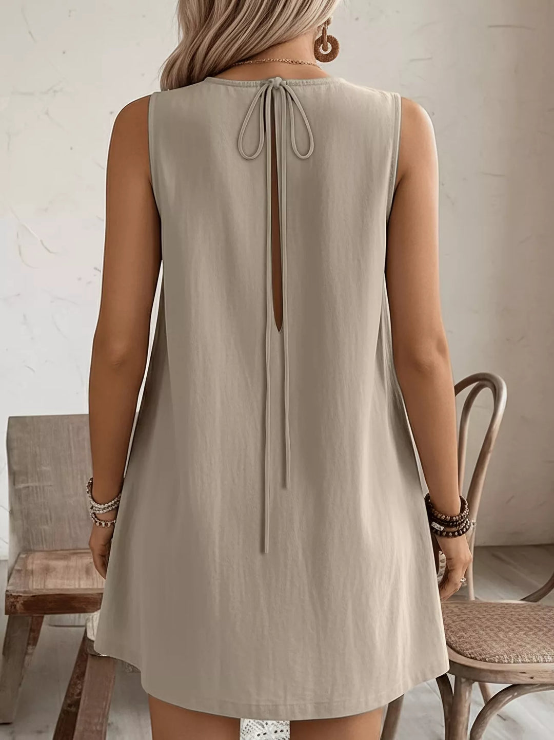 Ruffle-trim sleeveless mini dress with side pockets