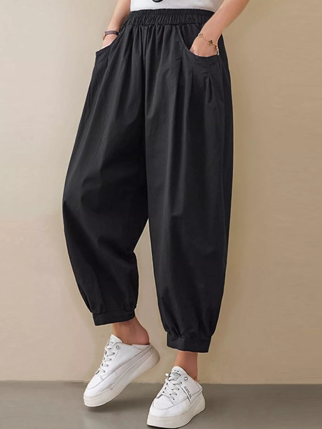 Black Pleated harem pants with elastic waist and tapered cuffs