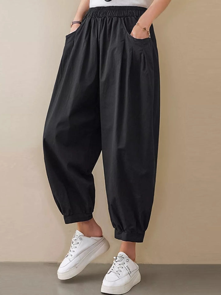 Black Pleated harem pants with elastic waist and tapered cuffs