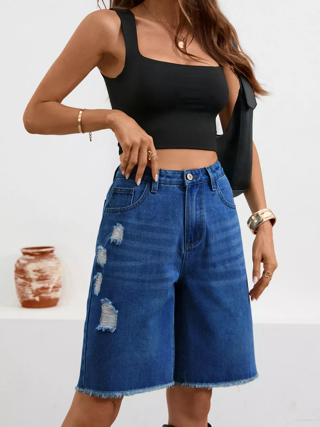 Distressed high-rise denim bermuda shorts with frayed hem