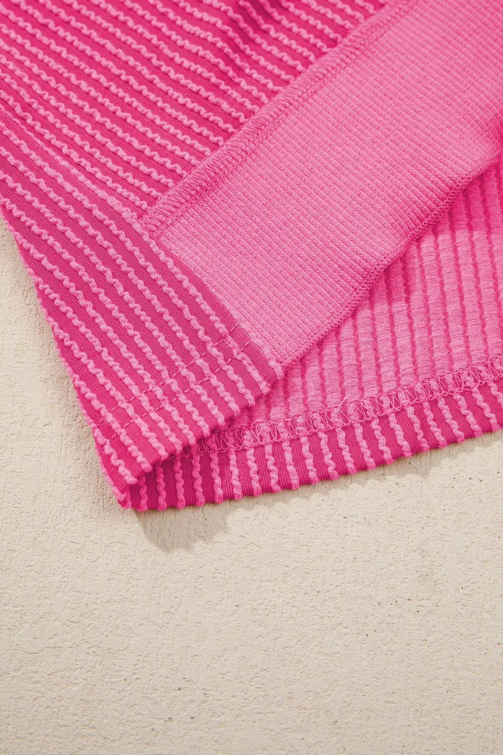 Ribbed knit short sleeve top with cutout bow-tie back