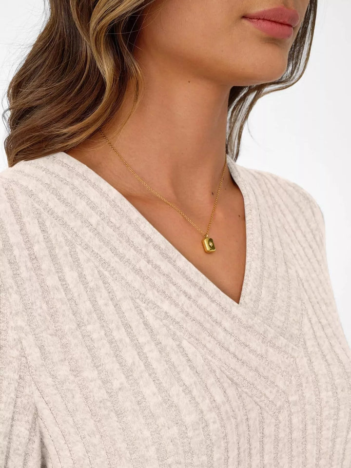 Ribbed knit v-neck top with blouson sleeves