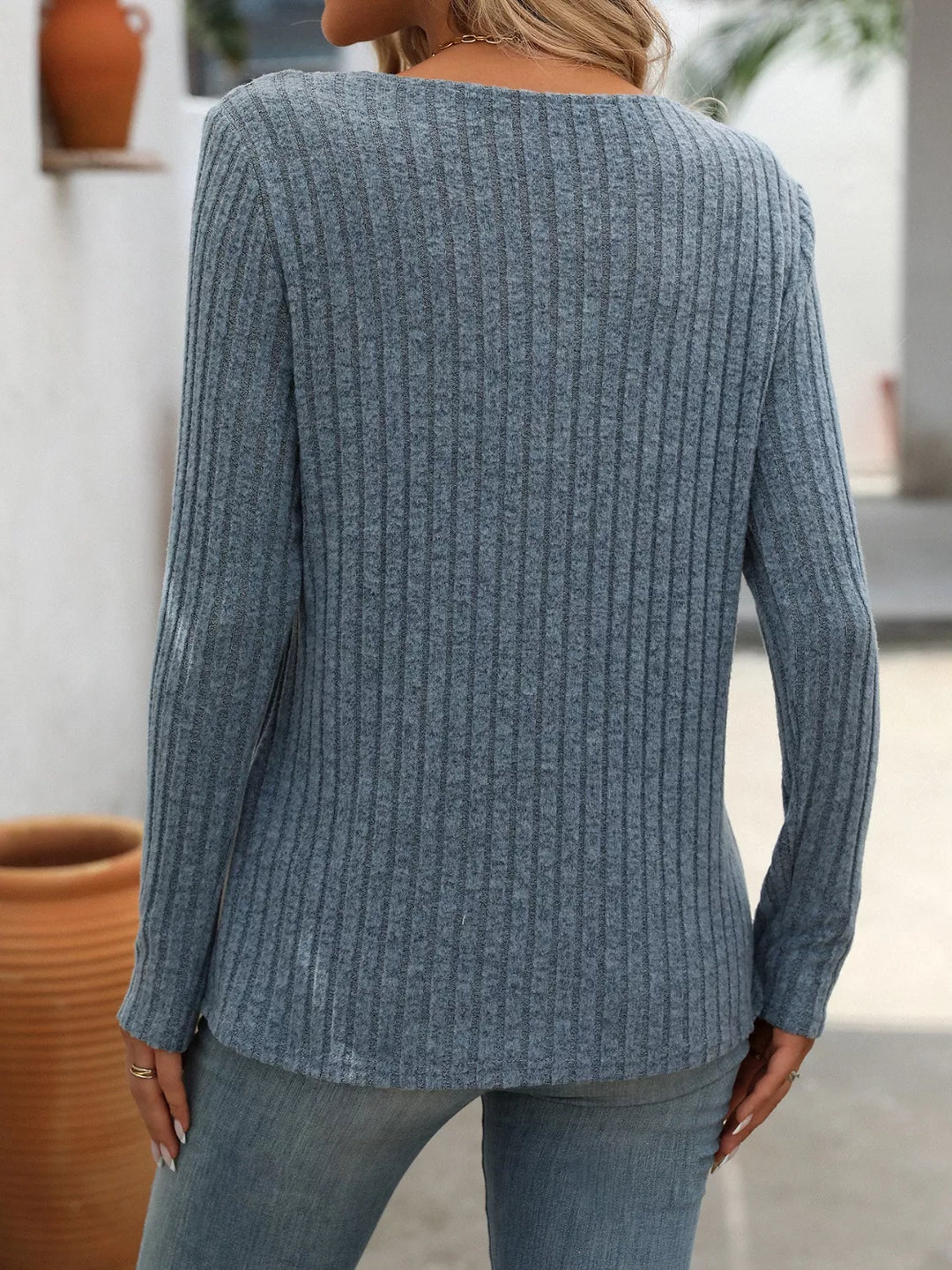 Ribbed knit long sleeve top with asymmetric button neckline