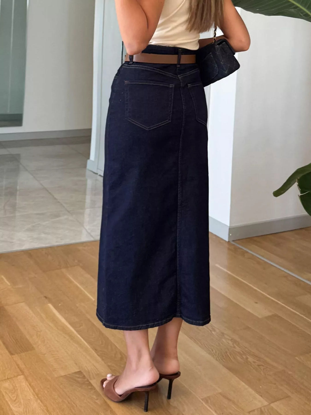 High-rise denim midi skirt with center front slit