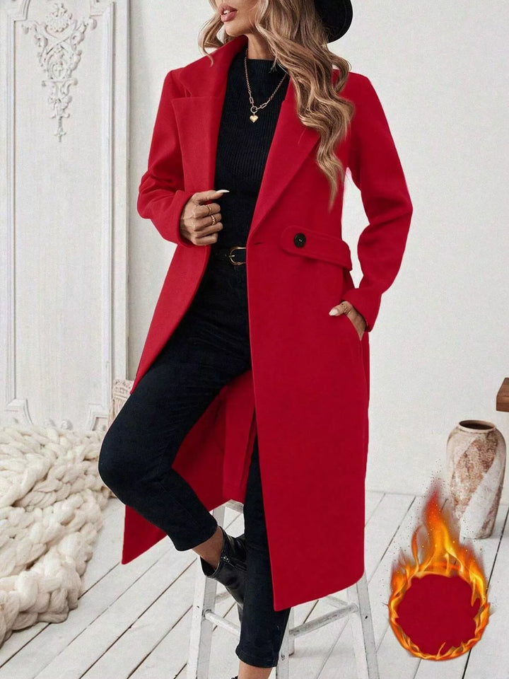 Longline notch lapel coat with single-button waist tab