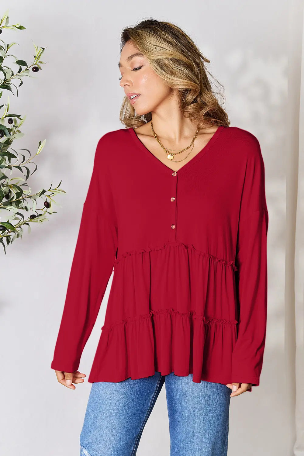 Half-button long sleeve blouse with tiered ruffle hem