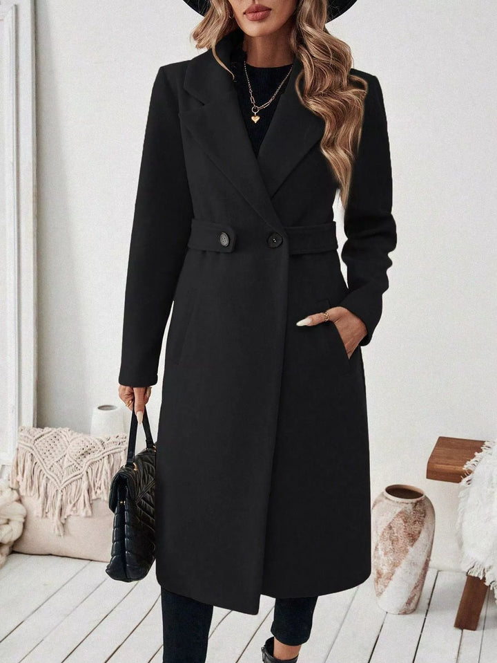 Longline notch lapel coat with single-button waist tab