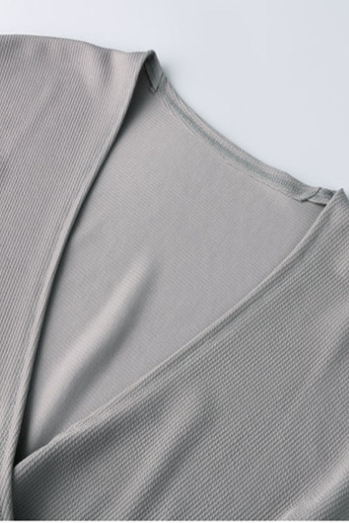 Ribbed surplice-neck top with side slit and cap sleeves